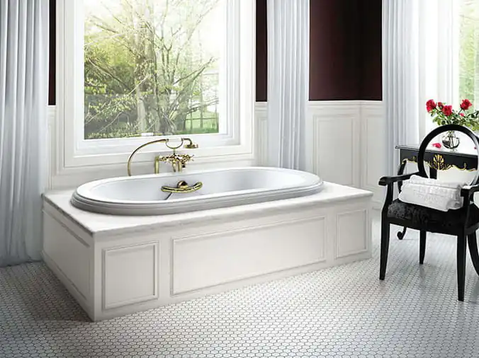 Large jacuzzi bathtub in front of a window