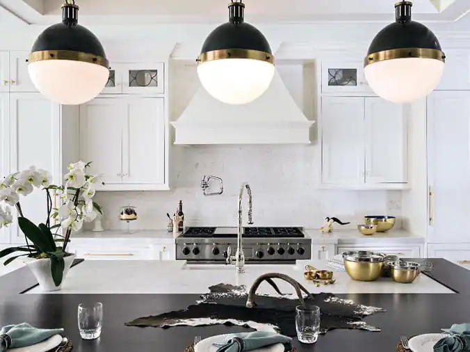 Kitchen with hanging lamps over island