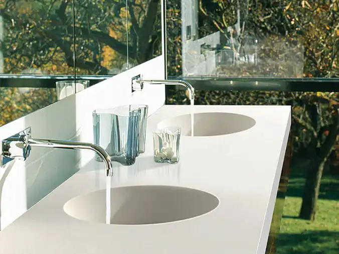 Dual bathroom sinks with polished stainless faucets