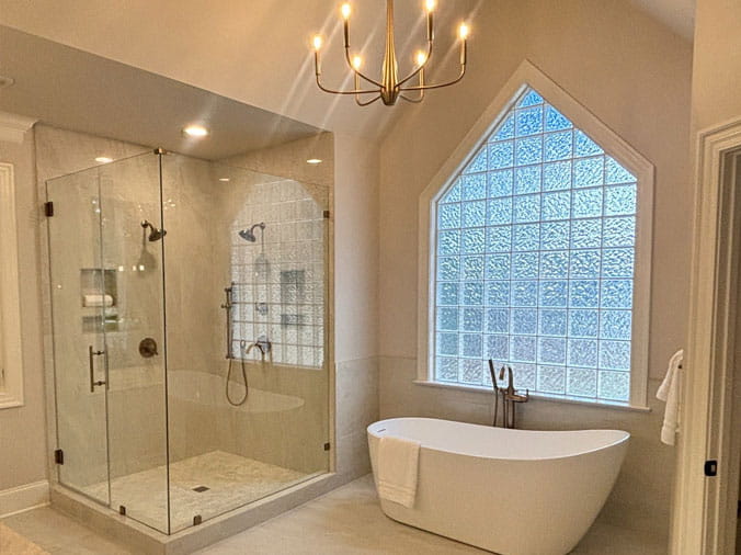 Bathroom with glass shower enclosure and free standing bathtub