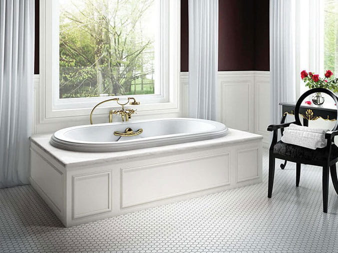 Large jacuzzi bathtub in front of a window
