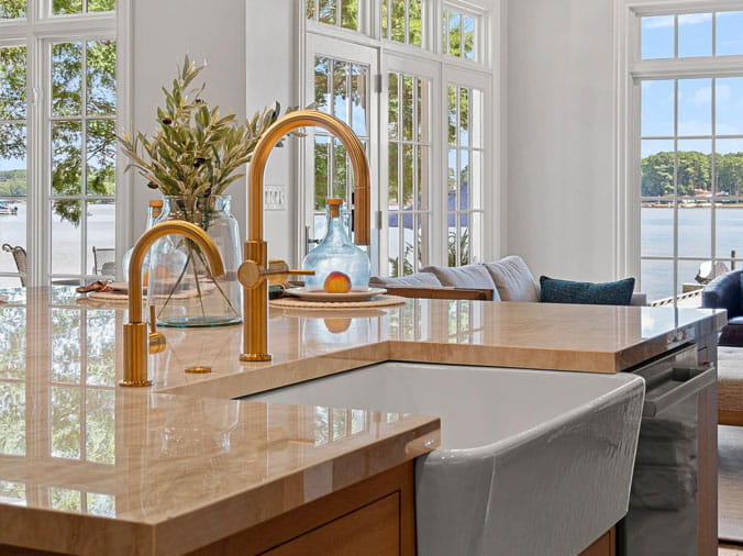 Kitchen with farmhouse sink and brass faucets and fittings