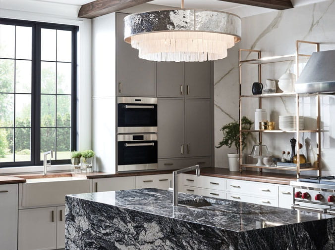 Kitchen with marble counters and dramatic ovberhead lighting