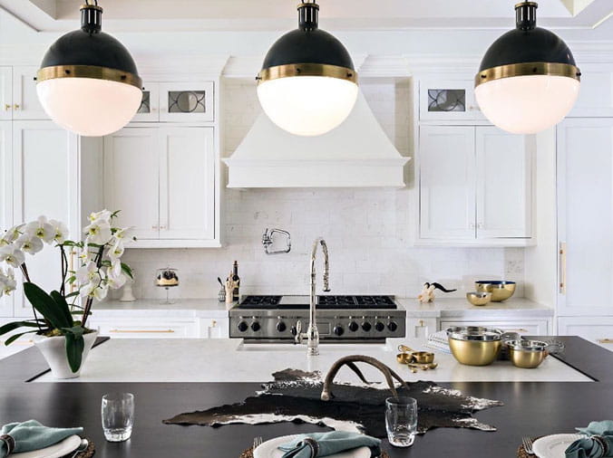 Kitchen with hanging lamps over island