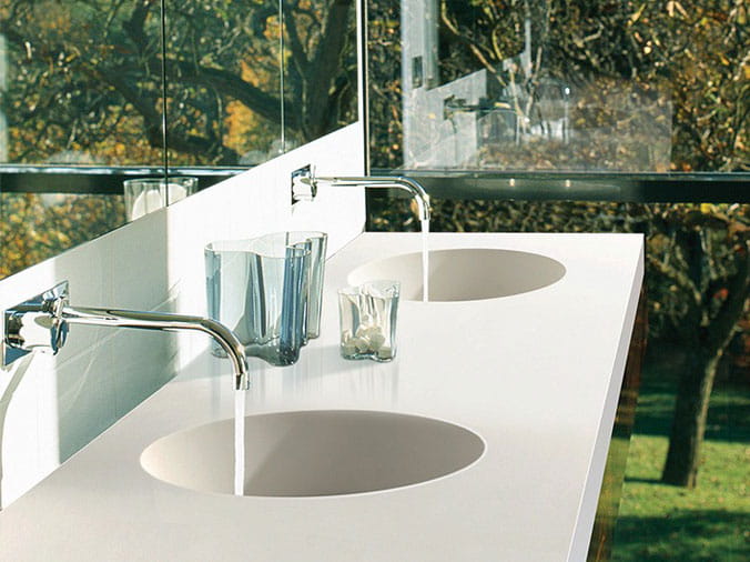 Dual bathroom sinks with polished stainless faucets